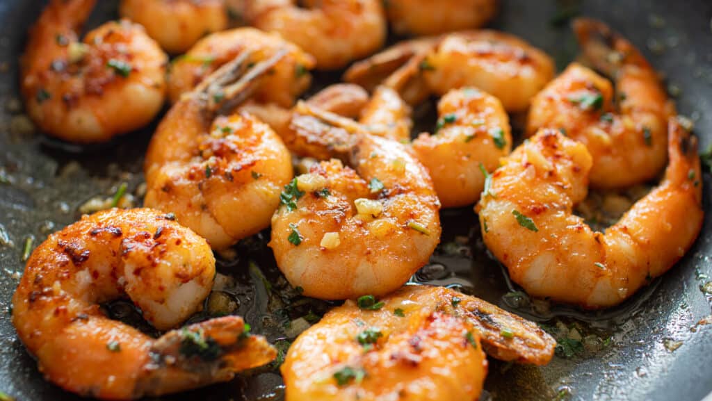 Closeup garlic butter shrimp in pan Garlic Shrimp at esmeraldas the best mexican restaurant in eureka