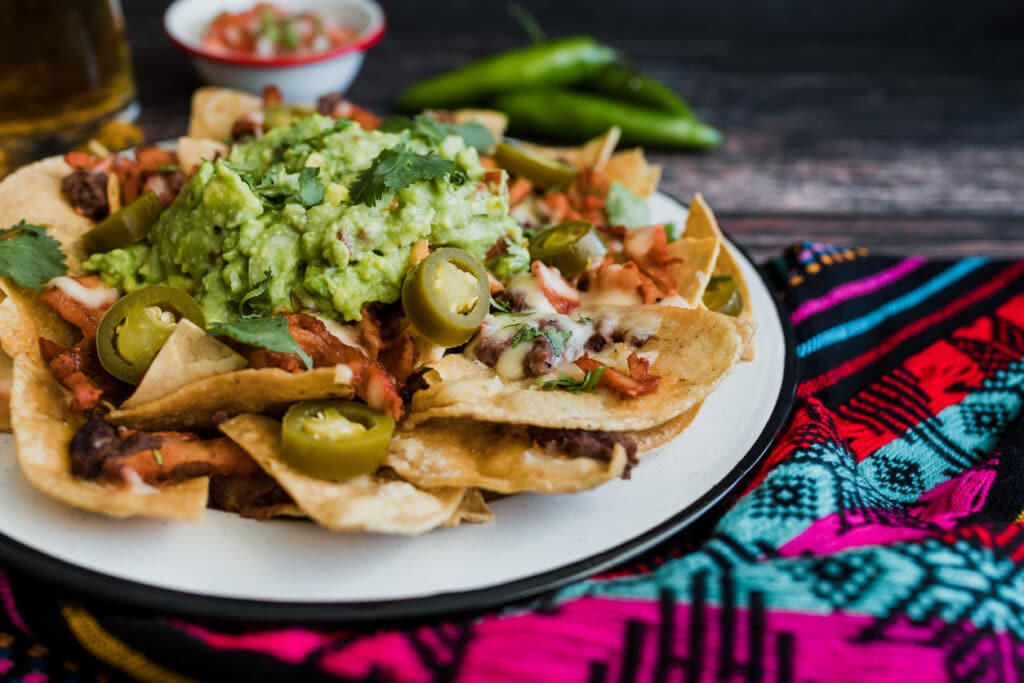 Mexican nachos chips with american cheese and avocado, traditional food in Mexico Latin America Nachos at esmeraldas the best mexican restaurant in eureka
