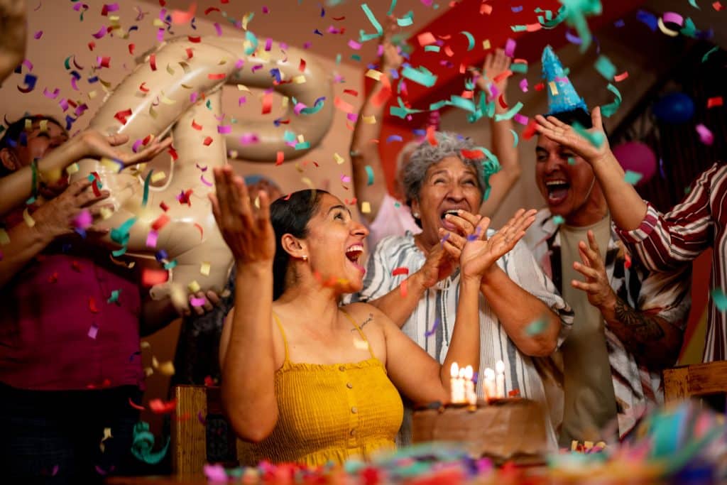 Mature woman celebrating birthday with family at home